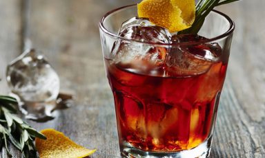 Negroni on ice with rosemary and lemon zest